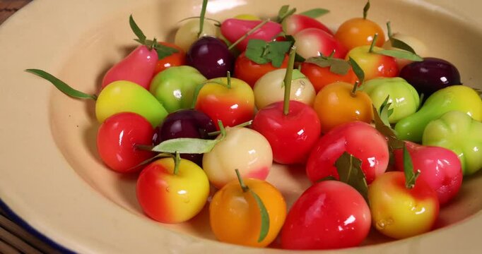 Colourful fruit vegetable shaped Thai sweet mung bean coconut milk desert luk chap candy variety pan rotate move