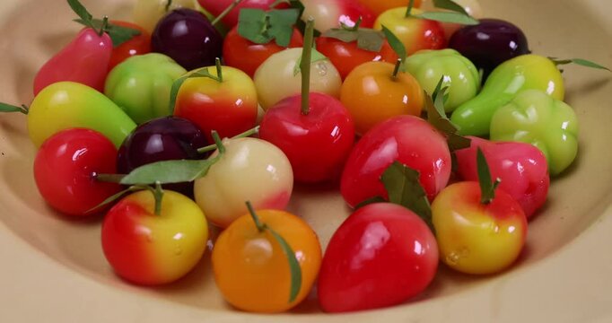 Colourful fruit vegetable shaped Thai sweet mung bean coconut milk desert luk chap candy variety pan rotate move