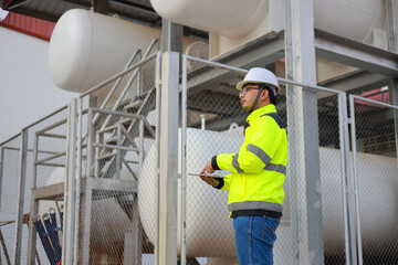 Portrait of professional man engineer working checking work place to keep liquid helium in industry.