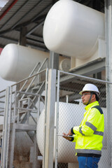 Portrait of professional man engineer working checking work place to keep liquid helium in industry.