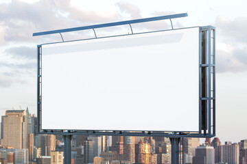 Blank white billboard on cityscape background at daytime, perspective view. Mock up, advertising concept