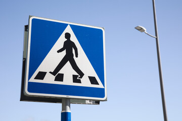 Swedish pedestrian crossing sign on blue sky