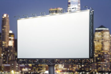 Fototapeta premium Blank white horizontal billboard on skyline background at evening, perspective view. Mock up, advertising concept