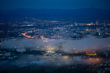High-angle view of city lights at night, and fog covering the city Gives a cool feeling. Many...
