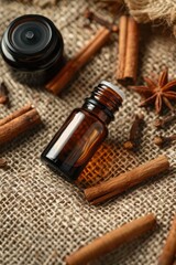 cinnamon essential oil on burlap background. selective focus