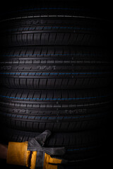 Car tires on a black background close-up. Auto service industry.