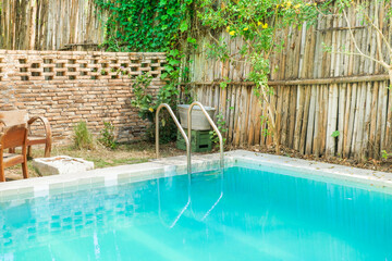 Empty blue Swimming pool with stair in summer time,refreshing blue swimming pool,summer vacation in...