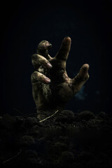 Creepy zombie hand on dark background with copy space. Halloween concept.