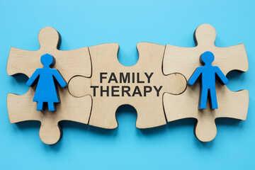 Family therapy concept. Puzzle pieces with figures and inscription.