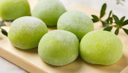 Delicious green mochi on wooden board. Traditional Japanese dessert. Rice cake. Sweet and tasty food
