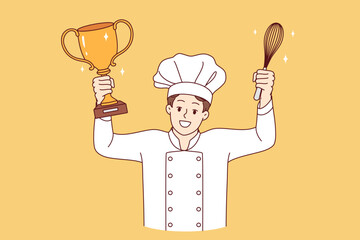 Man chef cook celebrates victory in professional culinary tournament, holds golden cup and whisk in hands. Restaurant chef in white uniform and hat won speed-cooking delicacy competition
