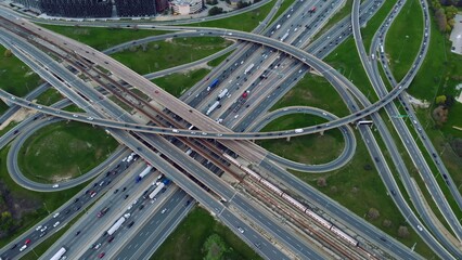 Metropolitan arteries pulsing with cars, aerial showcase of urban pace. Transportation web: Aerial...