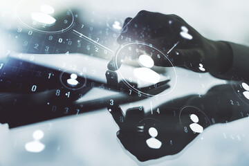 Double exposure of social network icons concept and hand working with a digital tablet on...