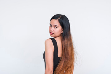 Young Asian woman in a sleek black bodysuit posing confidently