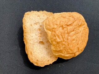 bread and butter. close up of a cracker. freshly baked ciabatta bread. Loaf of white bread cut into pieces close-up. Sliced bread isolated. Wheaten bread with bran cut slice. 