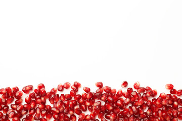 Many ripe juicy pomegranate grains on white background, flat lay. Space for text