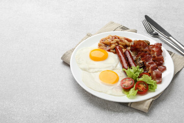 Delicious breakfast with sunny side up eggs on light table. Space for text