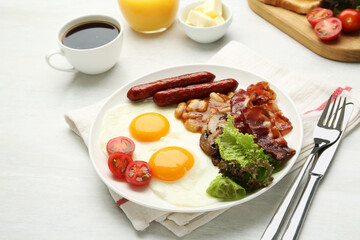Delicious breakfast with sunny side up eggs served on white table