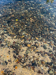 Pebble under the clear water at the river.