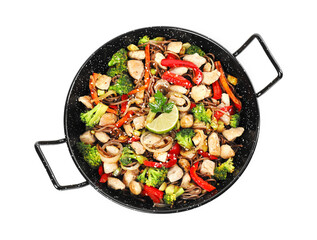 Stir-fry. Tasty noodles with meat and vegetables in wok isolated on white, top view