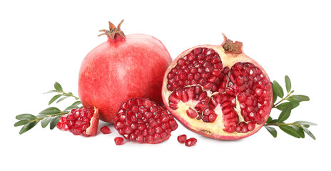 Fresh pomegranates and branches isolated on white