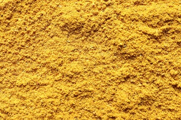 Dry curry powder as background, top view
