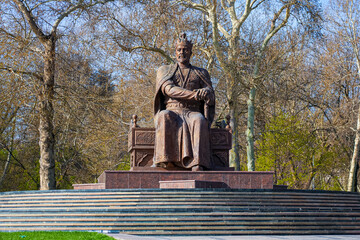 Amir Temur Monument in Samarkand, Uzbekistan, Central Asia - Bronze statue of the famous conqueror who founded the Timurid Empire seated on his throne