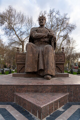 Amir Temur Monument in Samarkand, Uzbekistan, Central Asia - Bronze statue of the famous conqueror who founded the Timurid Empire seated on his throne