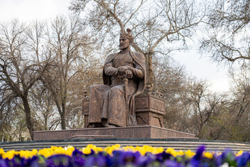 Amir Temur Monument in Samarkand, Uzbekistan, Central Asia - Bronze statue of the famous conqueror who founded the Timurid Empire seated on his throne