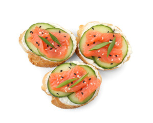 Tasty canapes with salmon, cucumber and cream cheese isolated on white, top view