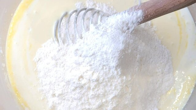Making cake batter, sifting flour to make it more airy. The process of adding flour to dough