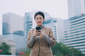 Professional Woman Using Smartphone in Urban Setting