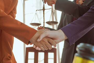 Shaking hands, A group of lawyers and clients engage in a professional meeting at a law office,...