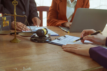 A group of lawyers and clients engage in a professional meeting at a law office, discussing agreements, contracts, and legal matters with a focus on justice and expert advice. - obrazy, fototapety, plakaty