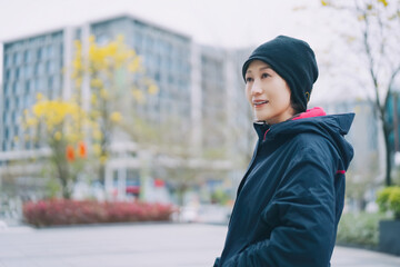 Smiling Woman Enjoying a Pleasant Walk in the City © zhouyilu