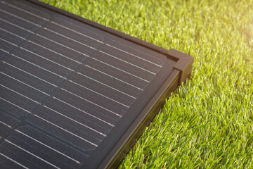 Electrical solar panel on the green grass. The modern technology of clean and renewable energy generation.