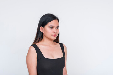 Elegant young Asian woman posing in a sleek black bodysuit, isolated on white background