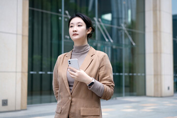 Professional Woman Navigating Corporate Environment with Smartphone