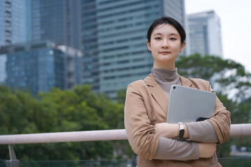 Confident Businesswoman with Tablet in Urban Setting