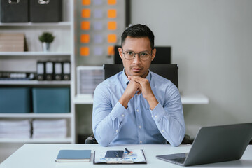 Business man sitting at his desk in the office.