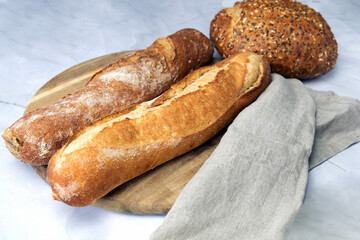 Two fresh baguettes on a cutting board.