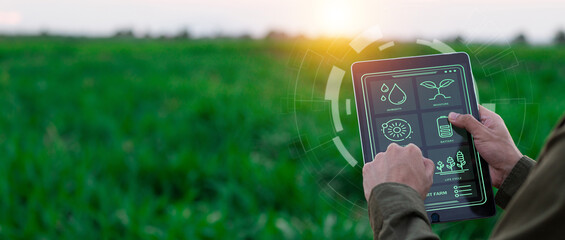 Farmers use agricultural technology in data analysis tablets and image icons. New technologies in...