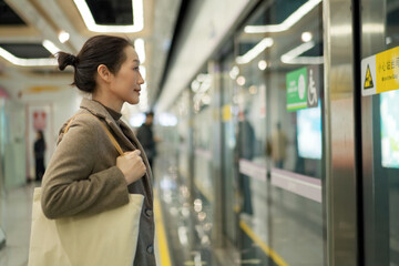 Woman Anticipating Arrival of Train in Subway
