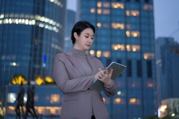 Professional Woman Working on Tablet in Urban Setting