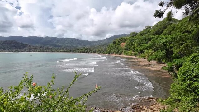 Stunning bay of Dominical. A pan over the surf beach Dominicalito. Paradise for surfers and nature lovers.