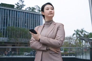 Confident Professional Businesswoman with Smartphone