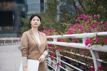 Professional Woman with Blooming Flowers in the City