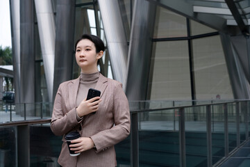 Professional Woman with Phone by Modern Architecture