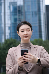 Professional Woman Checking Phone in Urban Setting