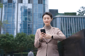 Professional Woman Using Smartphone in Urban Setting
